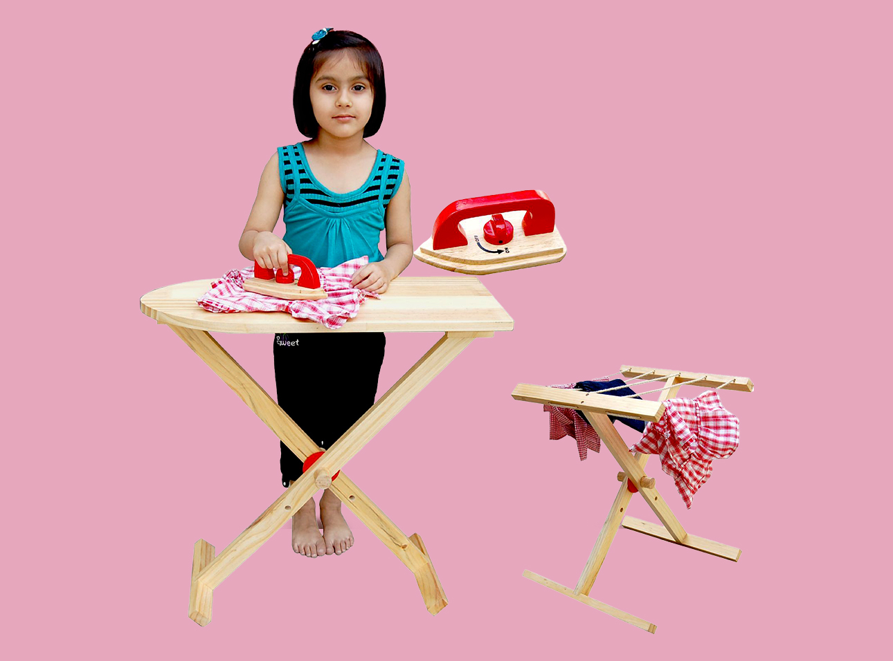 A kid is playing with wooden iron table and iron.